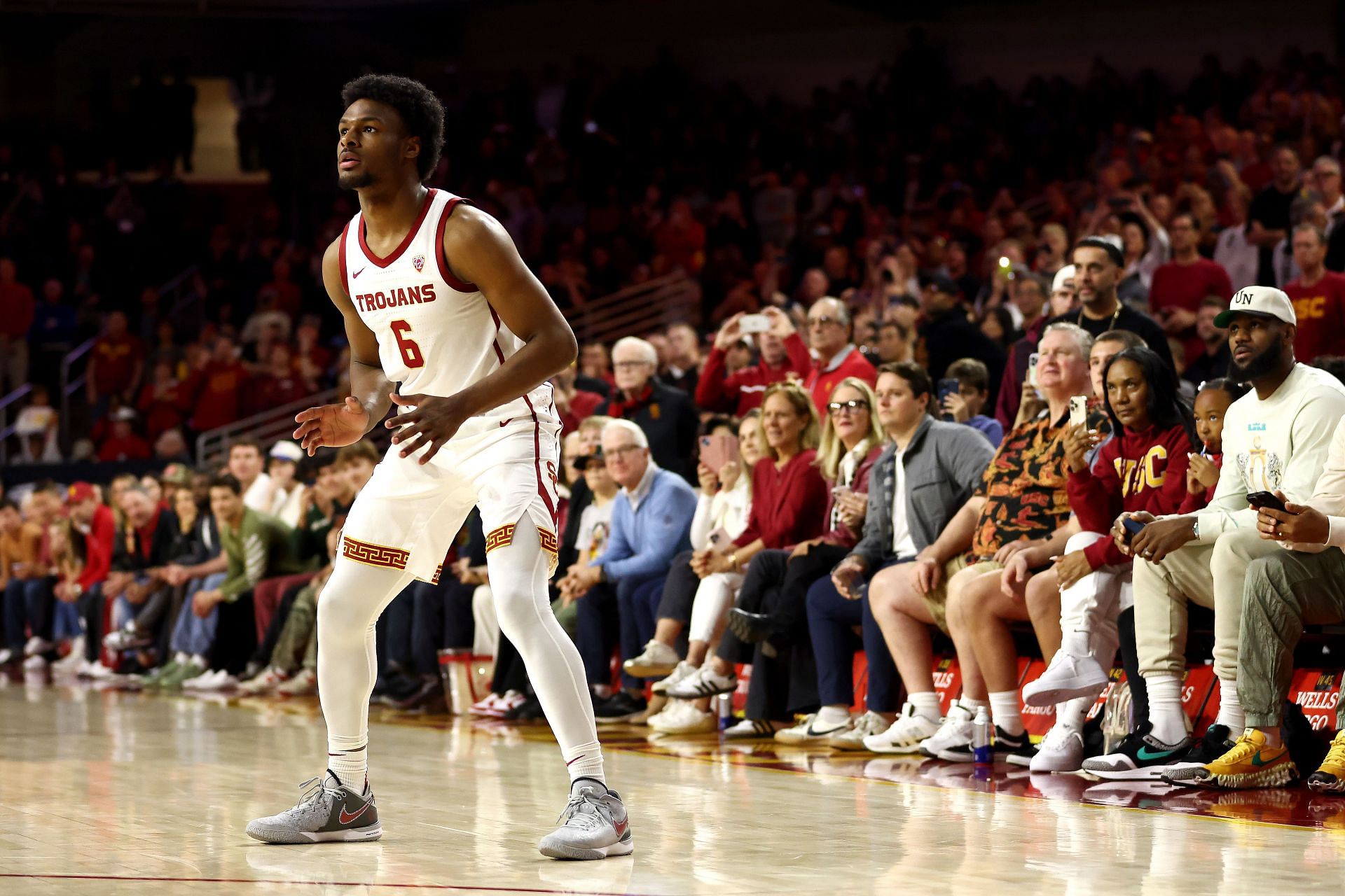 LeBron James looks on towards Bronny James #6 of the USC Trojans.